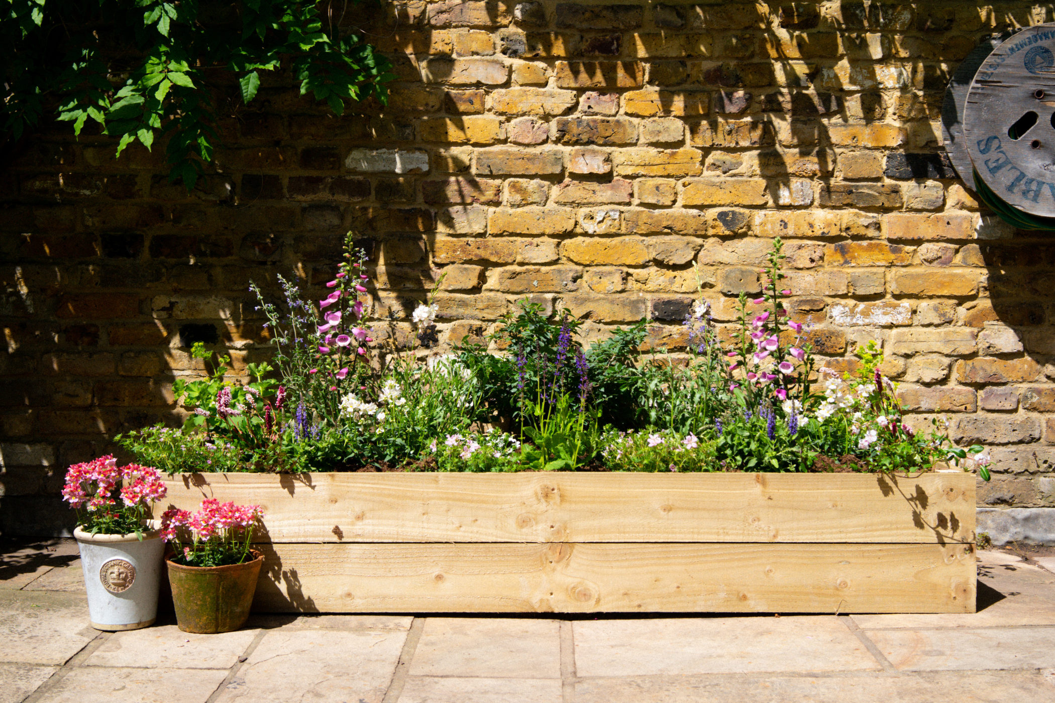 Dig Instant Bed in wooden raised planter in The Cottage theme